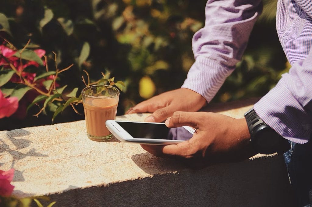 a person informing their family about their sailing trip using a smartphone