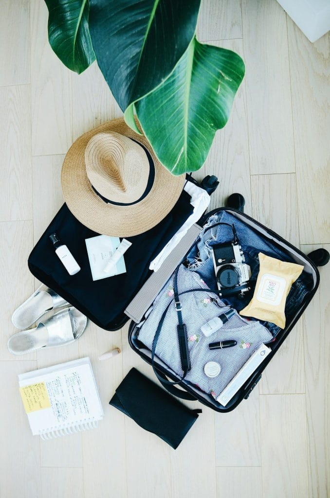 a suitcase packed with items for a sailing trip