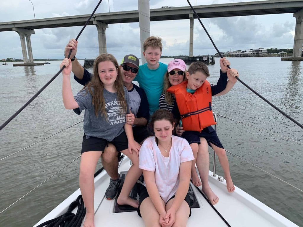 a family posing for a photo on a yacht