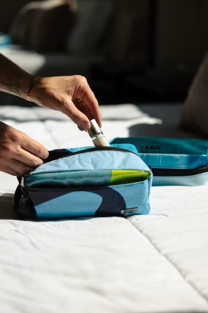 a person removing toiletries from a bag during a sailing trip